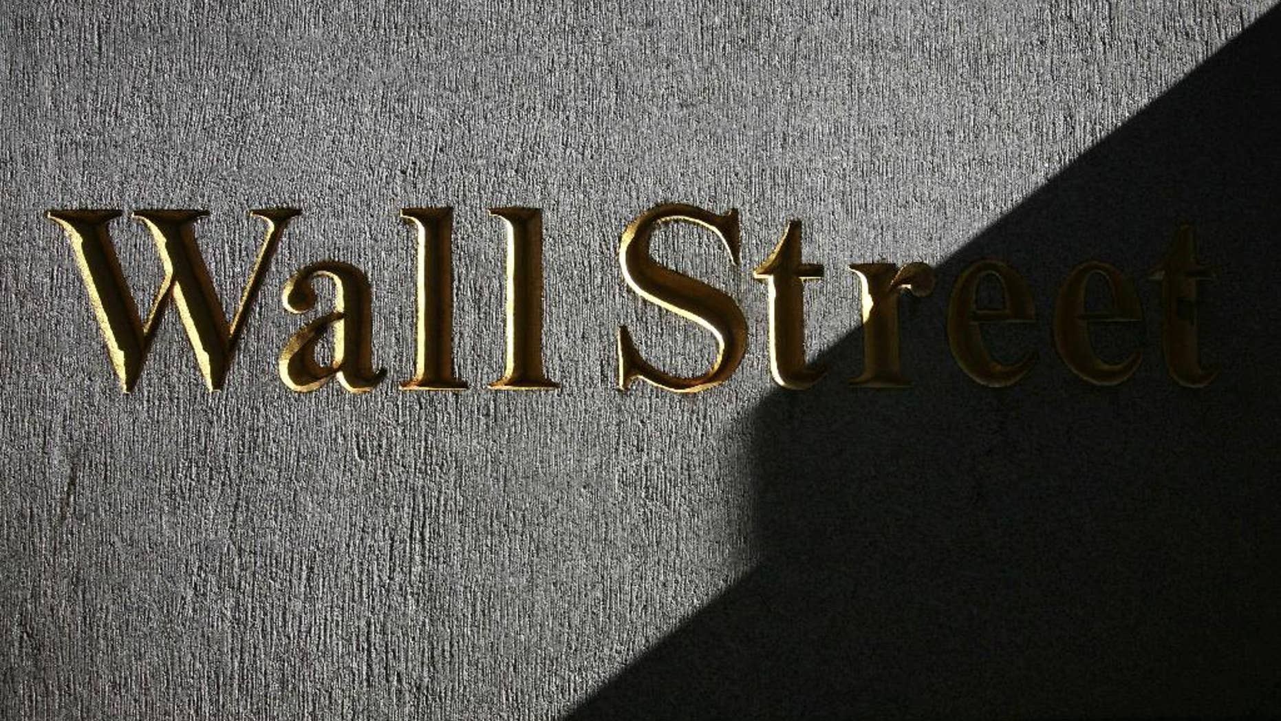 FILE - In this Monday, March 8, 2010, file photo, a sign for Wall Street is shown near the New York Stock Exchange. Global shares were mixed Wednesday Aug. 27, 2014 after the latest record close for the Standard & Poor's 500, with Europe off to a shaky start despite a strong day in Asia. (AP Photo/Mark Lennihan, File)