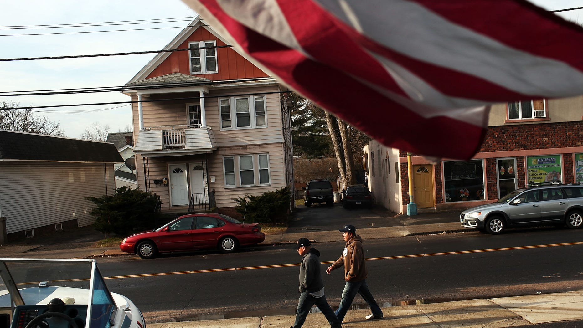 EAST HAVEN, CT - FEBRUARY 01: Two Latino residents walk down the street on February 1, 2012 in East Haven, Connecticut. Following an investigation by the FBI, four East Haven police officers were arrested last week and accused of abusing Latinos in the working class community of 28,000 people which was nearly predominately white a generation ago. A recent civil rights investigation which was released last month revealed a pattern of discriminatory policing in East Haven and the town has been warned by the U.S. Justice Department to make reforms. The arrested officers have been accused of subjecting Hispanics to beatings and false arrests among other things. Currently East Haven's Latino population is around 10 percent. (Photo by Spencer Platt/Getty Images)