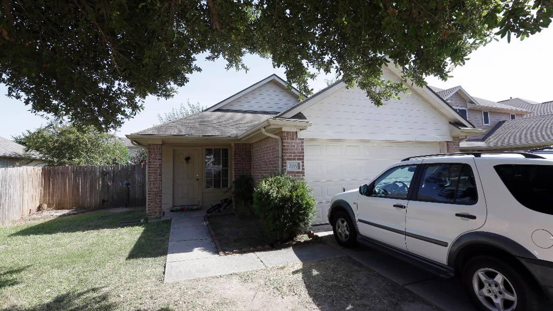 A house is shown, Sunday, Aug. 9, 2015, where eight people were killed on Saturday in Houston. A family of six children and two parents were handcuffed and fatally shot in the head at a Houston home by a man with a violent criminal history who had previously been in a relationship with the mother and had a dispute with her, authorities said Sunday. David Conley, 48, was charged with capital murder in the deaths. (AP Photo/David J. Phillip)