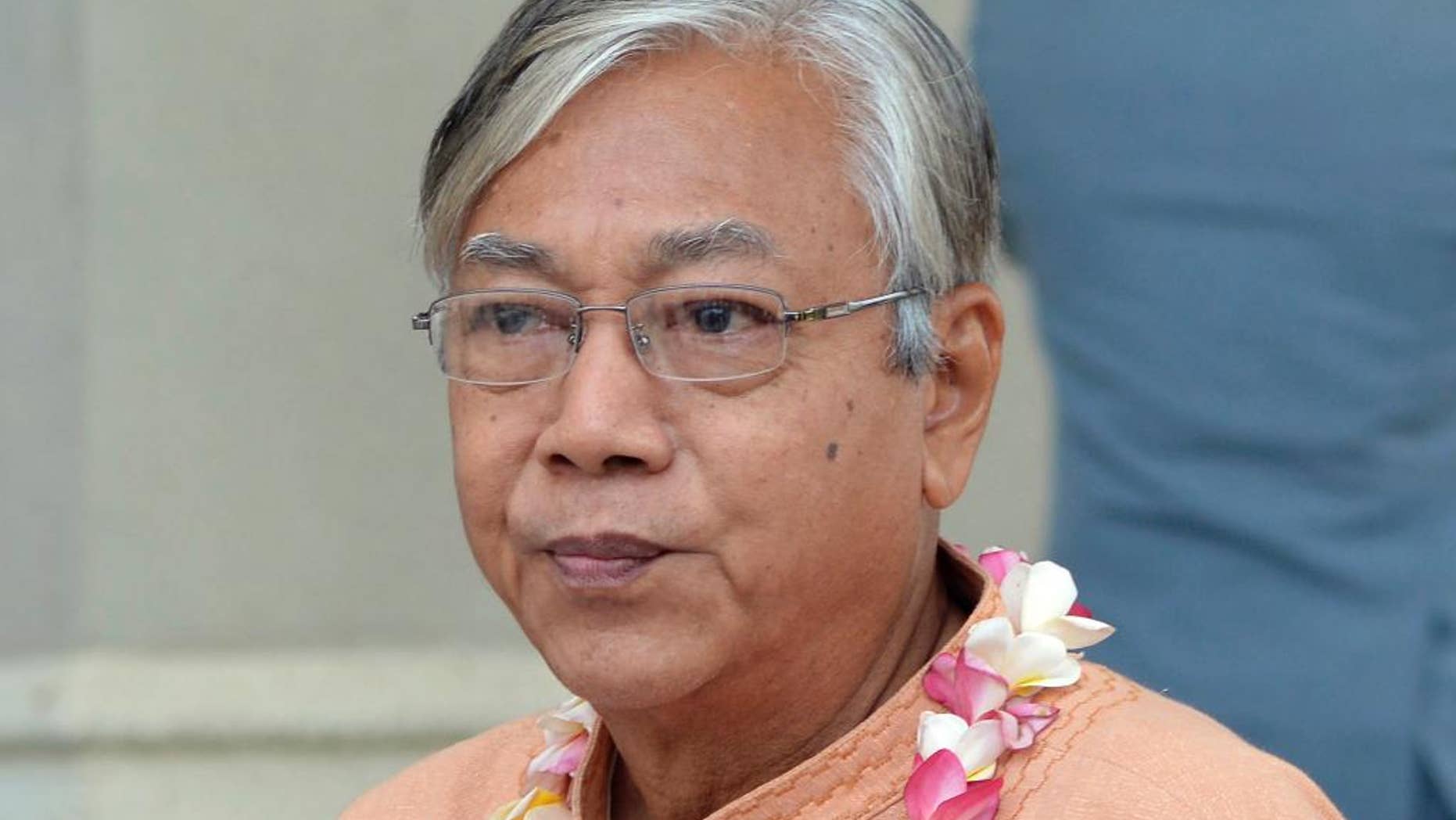 FILE - In this April 12, 2016, file photo, Myanmar's President Htin Kyaw attends a ceremony to mark the country's annual water festival at the Presidential Palace in Naypyitaw, Myanmar. Myanmar's new president on Sunday, April 17, 2016, pledged to continue efforts to release remaining political prisoners as part of the sweeping democratic changes his government envisions after a half-century of military control.(AP Photo/Aung Shine Oo, File)