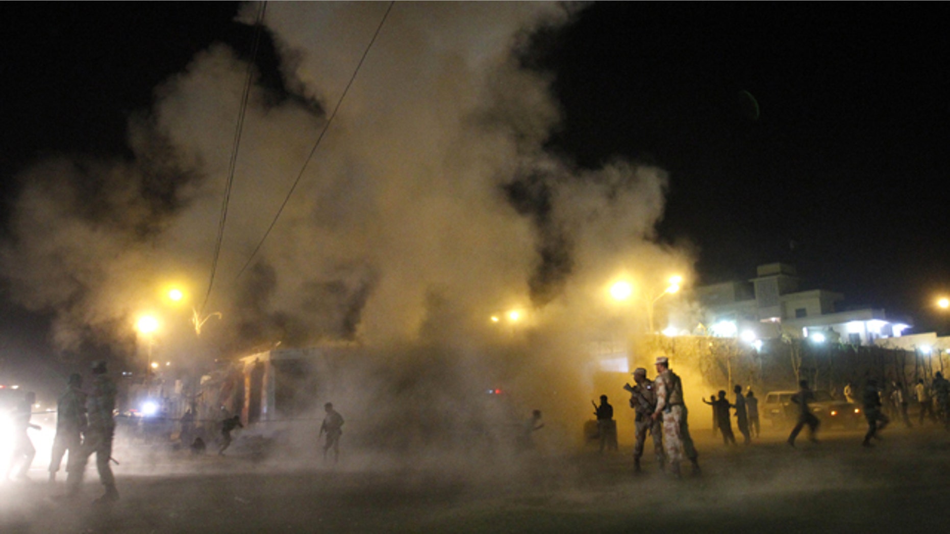 Nov. 21, 2012: People run away after a second blast outside a Shiite mosque during a mourning congregation in Karachi, Pakistan.