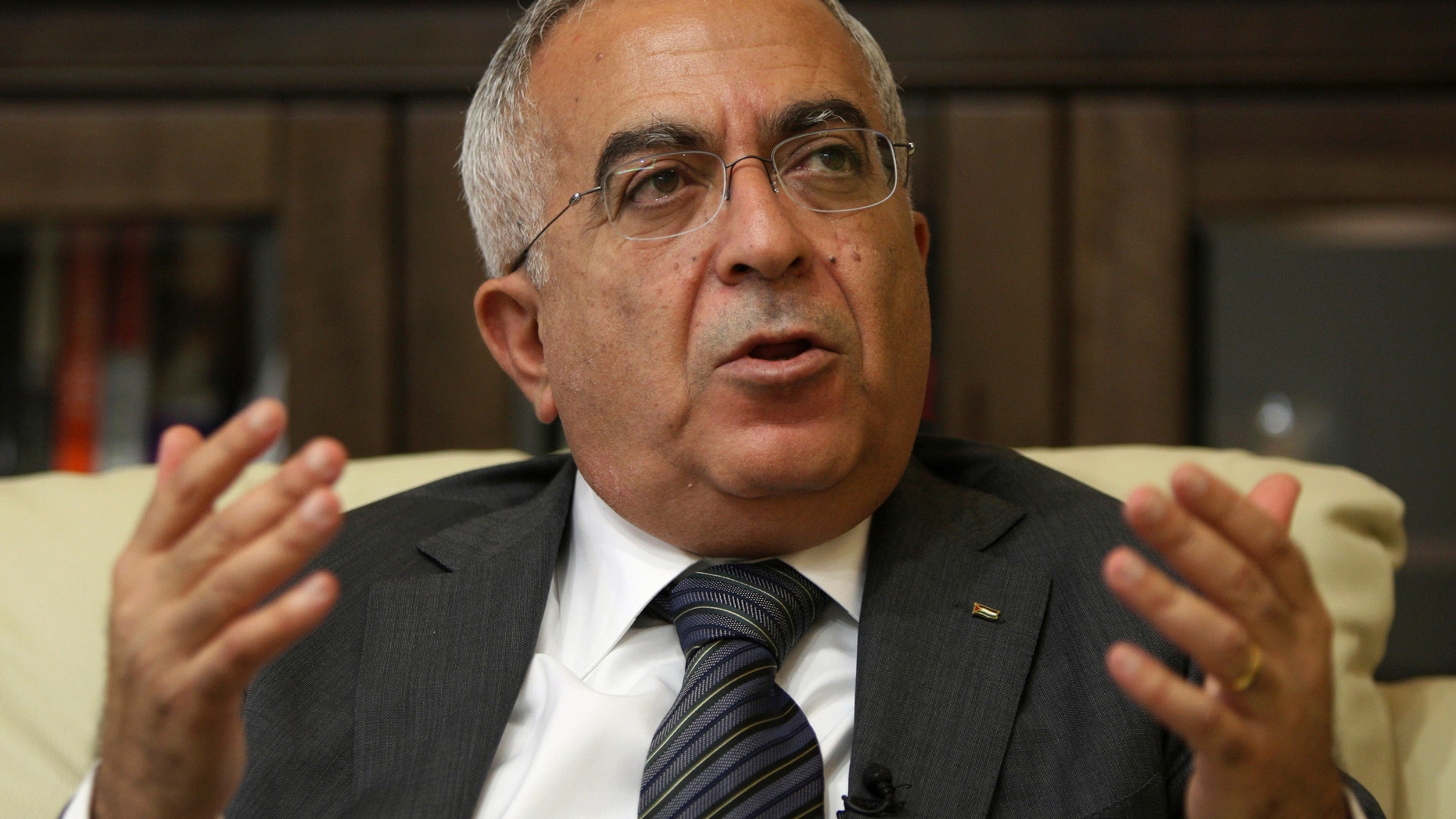 FILE - In this Tuesday, June 28, 2011 file photo, Palestinian Prime Minister Salaam Fayyad speaks during an interview with The Associated Press in the West Bank city of Ramallah. Palestinian officials say Fayyad has officially submitted his resignation, and is waiting for a reply from President Mahmoud Abbas.(AP Photo/Majdi Mohammed, File)