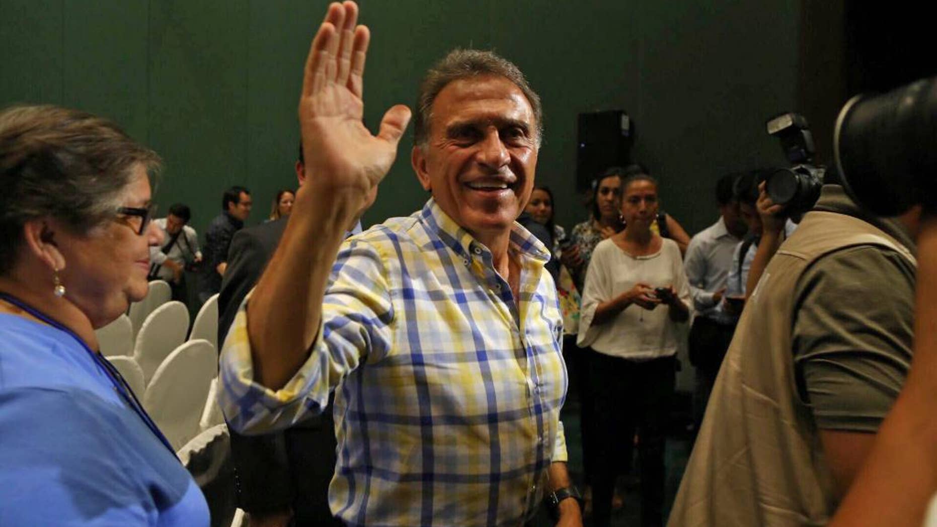 Miguel Angel Yunes waves at supporters as he arrives to give a news conference in Veracruz, Mexico, Sunday, June 5, 2016. Mexico's ruling party appeared to have suffered a series of stinging defeats in the 12 governorships up for grabs in state elections, according to preliminary vote counts Monday. Hobbled by corruption scandals, violence and a weak economy, the ruling Institutional Revolutionary Party lost four states including Veracruz, a state of 8 million that is the third most-populous in the country. (AP Photo/Ilse Huesca)