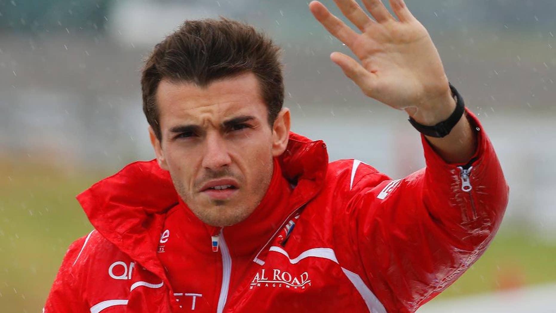 Marussia driver Jules Bianchi of France waves during drivers' parade before the Japanese Formula One Grand Prix at the Suzuka Circuit in Suzuka, central Japan, Sunday, Oct. 5, 2014. Bianchi has been taken to hospital and is unconscious following a crash during the Japanese Grand Prix. The race was red-flagged with nine laps to go after Bianchi went off at Turn 7, where Sauber's Adrian Sutil had crashed earlier. (AP Photo/Shizuo Kambayashi)