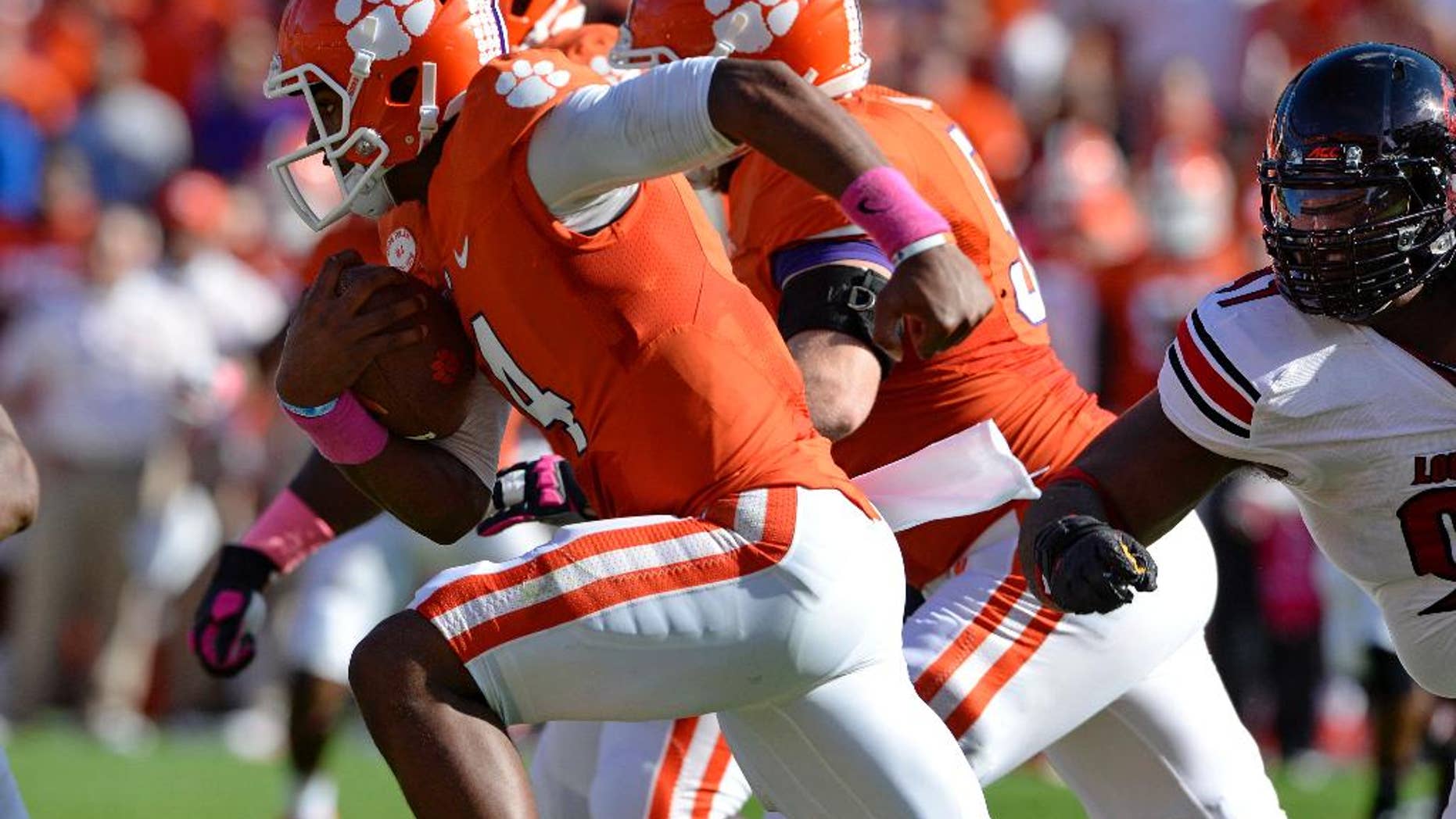 Clemson quarterback Deshaun Watson rushes out of the pocket during an NCAA college football game against Louisville in Clemson, S.C., Saturday, Oct. 11, 2014. (AP Photo/ Richard Shiro)