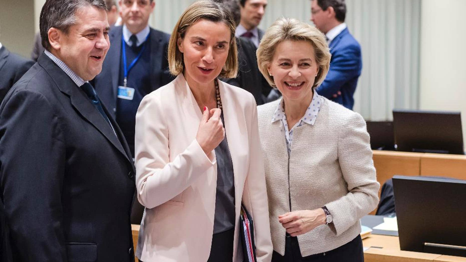 EU foreign policy chief Federica Mogherini, center, talks with Germany's Defense Minister Ursula von der Leyen, right, and Germany's Foreign Minister Sigmar Gabriel during an EU Foreign and Defense ministers meeting at the EU Council building in Brussels, Monday, March 6, 2017. The European Union is set to give the greenlight to establish a headquarters for its military training missions in Somalia, Mali and the Central African Republic. (AP Photo/Geert Vanden Wijngaert)