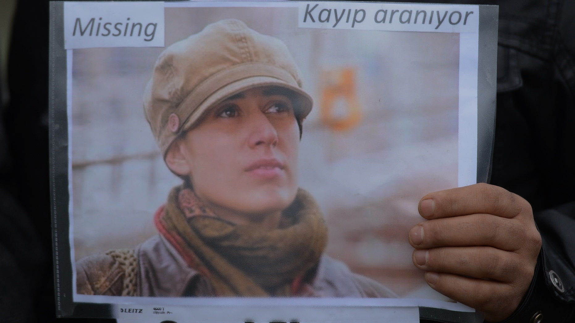 A member of the Istanbul-based Association For Families With Lost Relatives hands out flyers with photos of Sarai Sierra, a New York City woman who disappeared while on vacation in Istanbul, urging anyone with information to call police, in Istanbul, Turkey, Thursday, Jan. 31, 2013. Sierra, a 33 year-old mother of two, has been missing since Jan. 21, when she was due to return home. Turkish police have set up a special unit to search for her and are trying to trace a man she had been in contact with during her stay.(AP Photo)
