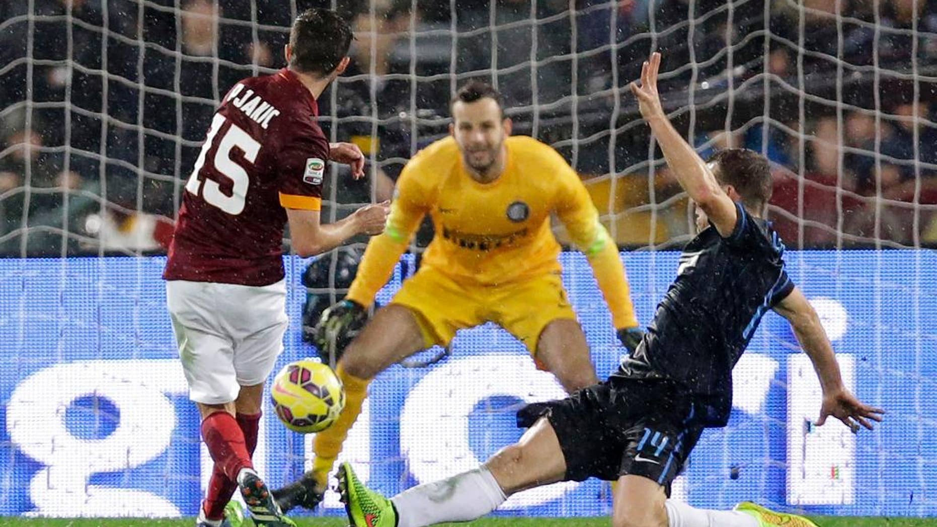 Roma's Miralem Pjanic, left, scores during a Serie A soccer match between Roma and Inter Milan at Rome's Olympic Stadium, Sunday, Nov. 30, 2014. (AP Photo/Andrew Medichini)