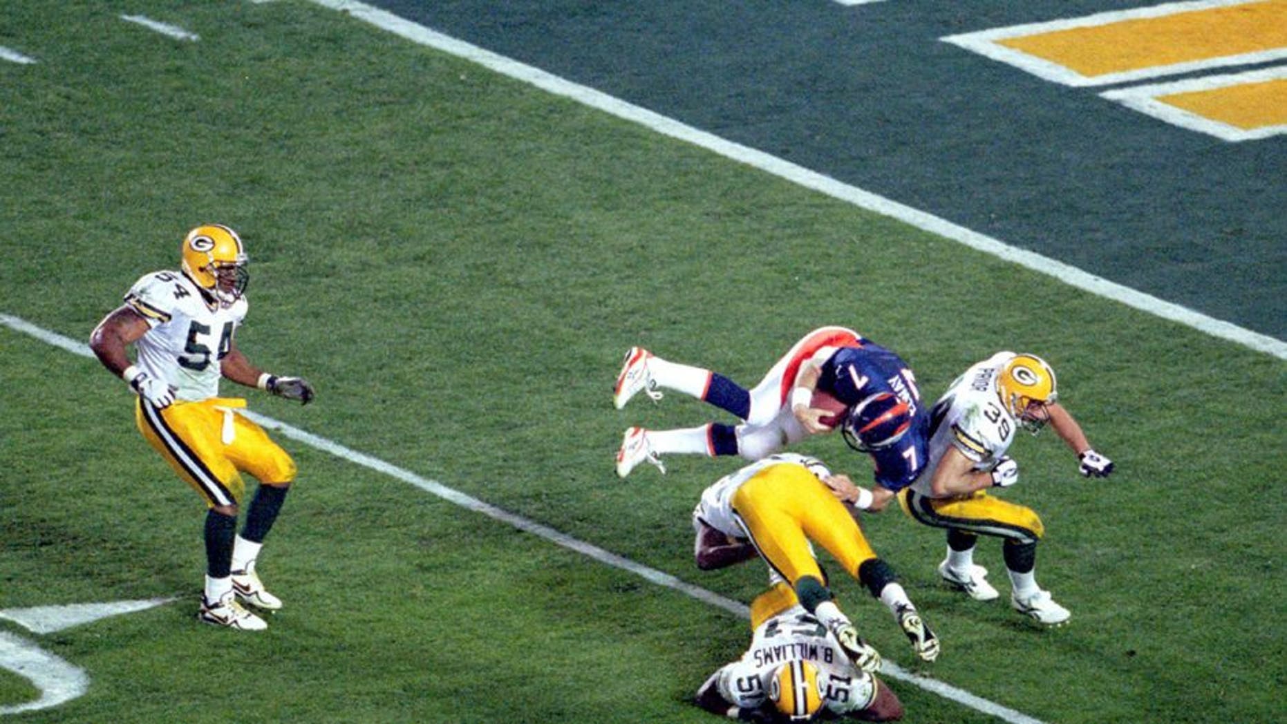 Denver quarterback John Elway goes airborne to pick up a first down in Super Bowl XXXII at Qualcomm Stadium in San Diego, CA. The Broncos defeated the Green Bay Packers 31-24 on 1/25/1998. (Photo by Kevin Reece/Getty Images)