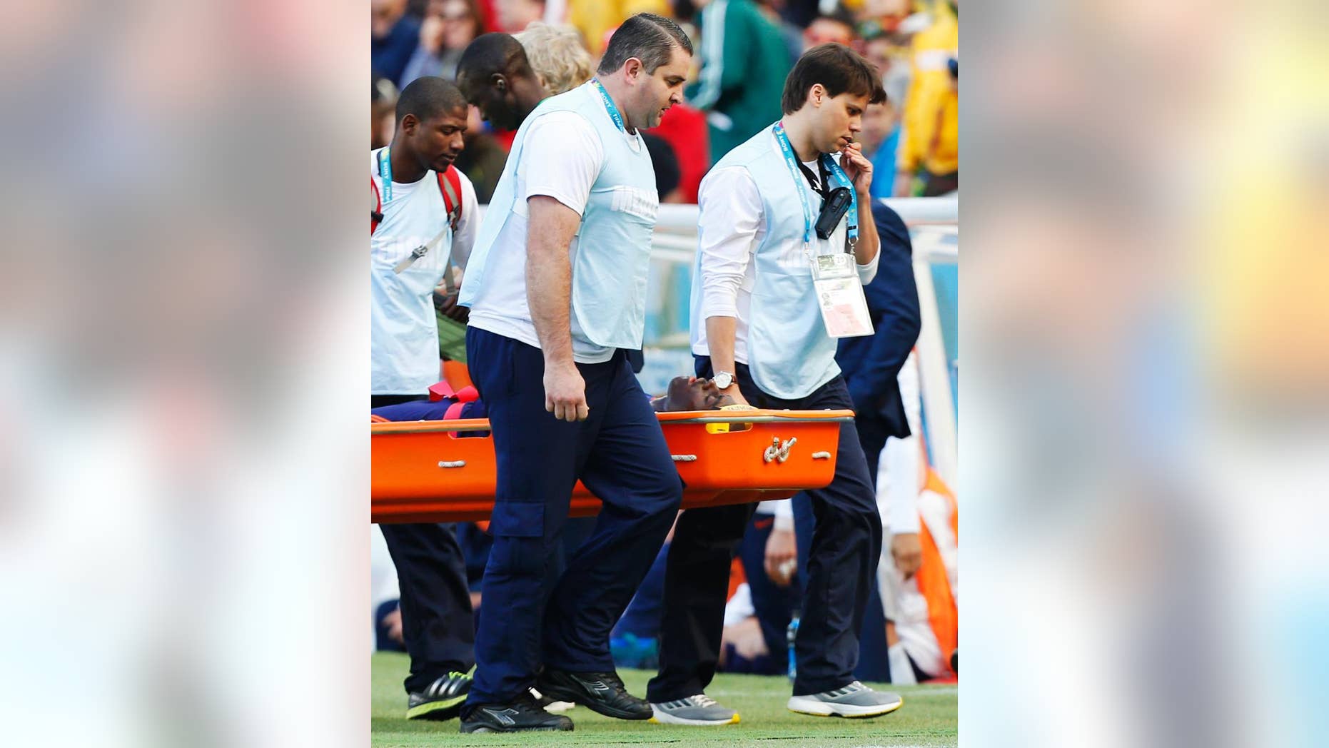 Netherlands' Bruno Martins Indi is carried off the pitch in a stretcher after a collision with Australia's Tim Cahill during the group B World Cup soccer match between Australia and the Netherlands at the Estadio Beira-Rio in Porto Alegre, Brazil, Wednesday, June 18, 2014. (AP Photo/Jon Super)