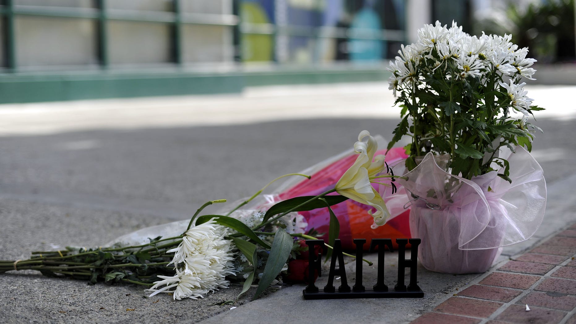 LOS ANGELES, CA - FEBRUARY 28: Flowers are placed in front of the building at the 900 block of South Flower Street where Marie Osmonds son Michael Blosil committed suicide on February 28, 2010 in Los Angeles, California. (Photo by Toby Canham/Getty Images)