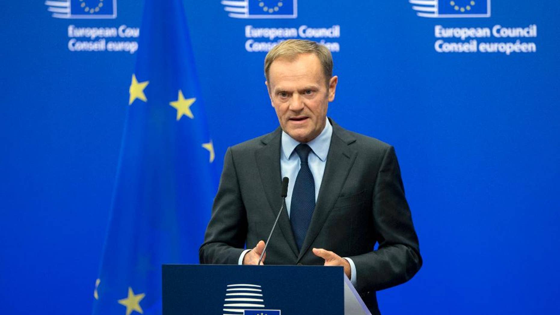 FILE- In this Wednesday, Nov. 9, 2016 file photo, European Council President Donald Tusk reads a statement during a media conference at the EU Council building in Brussels. Tusk says he thinks the European Union will extend sanctions against Russia, but that it will be harder to preserve the West's unity on Moscow when Donald Trump is U.S. president. (AP Photo/Virginia Mayo, File)