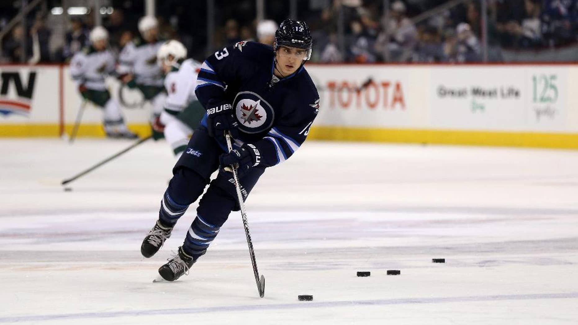 Winnipeg Jets' Brandon Tanev (13), newly signed from Providence College, attends warmups prior to NHL hockey action against the Minnesota Wild in Winnipeg, Manitoba, Sunday, April 3, 2016. (Trevor Hagan/The Canadian Press via AP) MANDATORY CREDIT