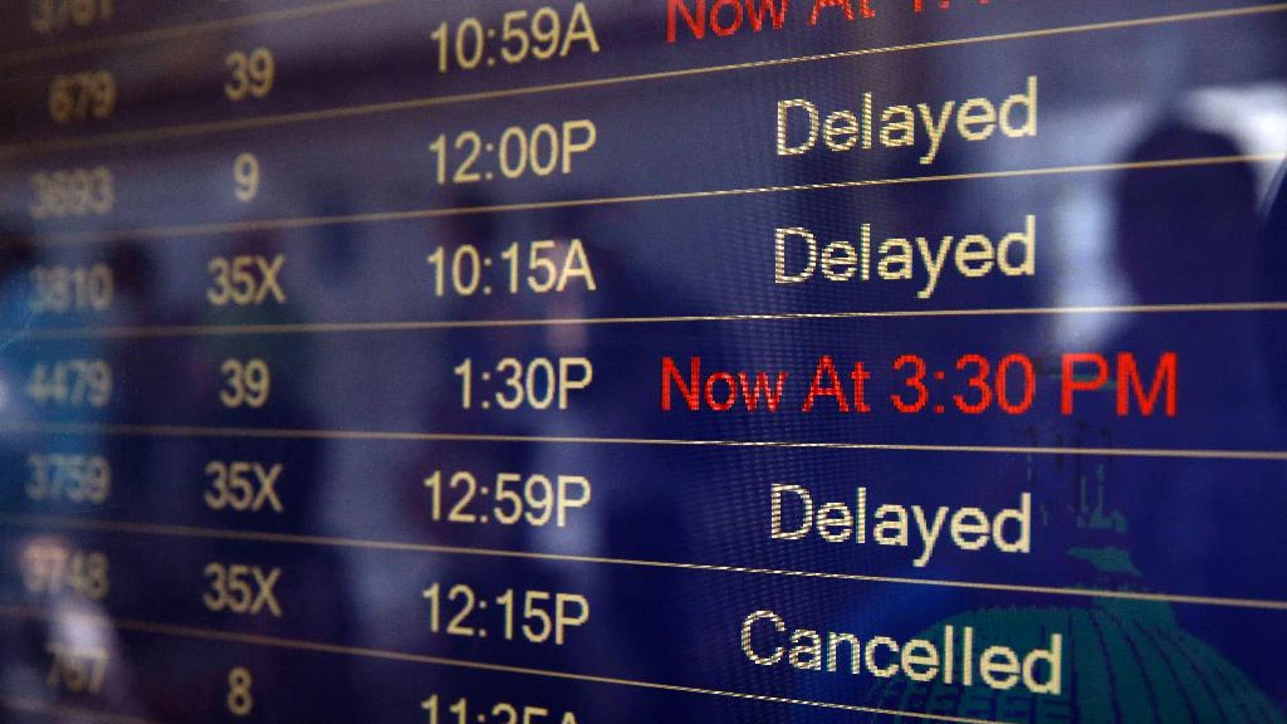 The Latest: Passengers take flight delays in stride after FAA announces