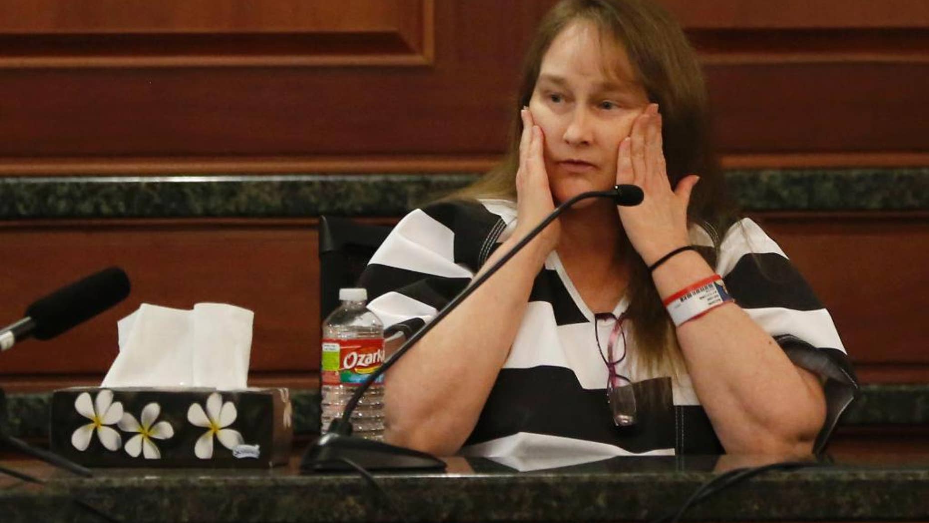 FILE - In a Dec. 16, 2014 file photo, Kim Williams, the estranged wife of Eric Williams, testifies during the punishment phase of Eric Williams' capital murder trial at the Rockwall County Courthouse in Rockwall, Texas. Williams pleaded guilty Tuesday, Dec. 30, 2014 to murder and was sentenced to 40 years in prison after earlier testifying that she helped her husband gun down a district attorney, his wife and a top assistant in a revenge plot. Williams appeared in court two weeks after her husband, Eric Williams, was sentenced to death for one of the three killings. (AP Photo/The Dallas Morning News, Vernon Bryant, Pool, File)