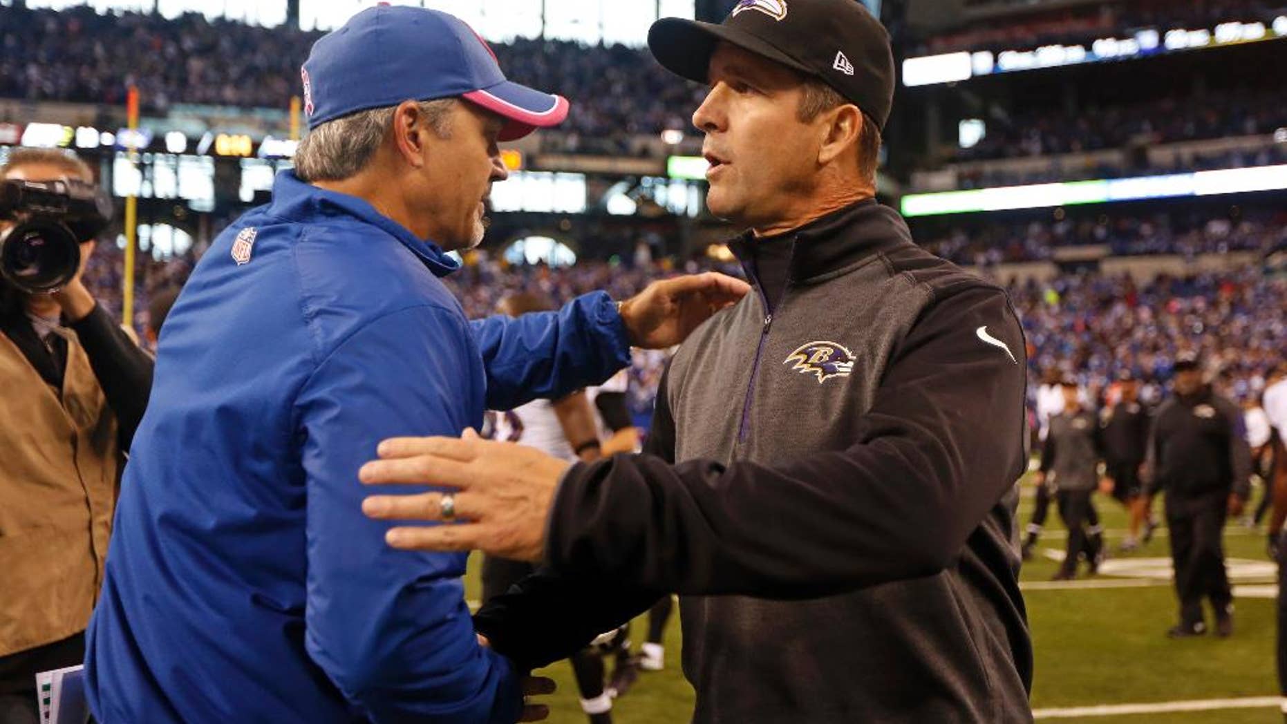 Indianapolis Colts head coach Chuck Pagano, left, greets Baltimore Ravens head coach John Harbaugh following an NFL football game in Indianapolis, Sunday, Oct. 5, 2014. The Colts defeated the Ravens 20-13. (AP Photo/Jeff Roberson)