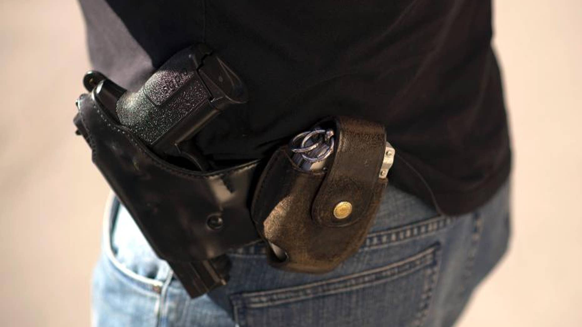 A SIG-Sauer Pro gun and handcuffs carried by a French policeman in Persan, outside Paris, on September 5, 2013