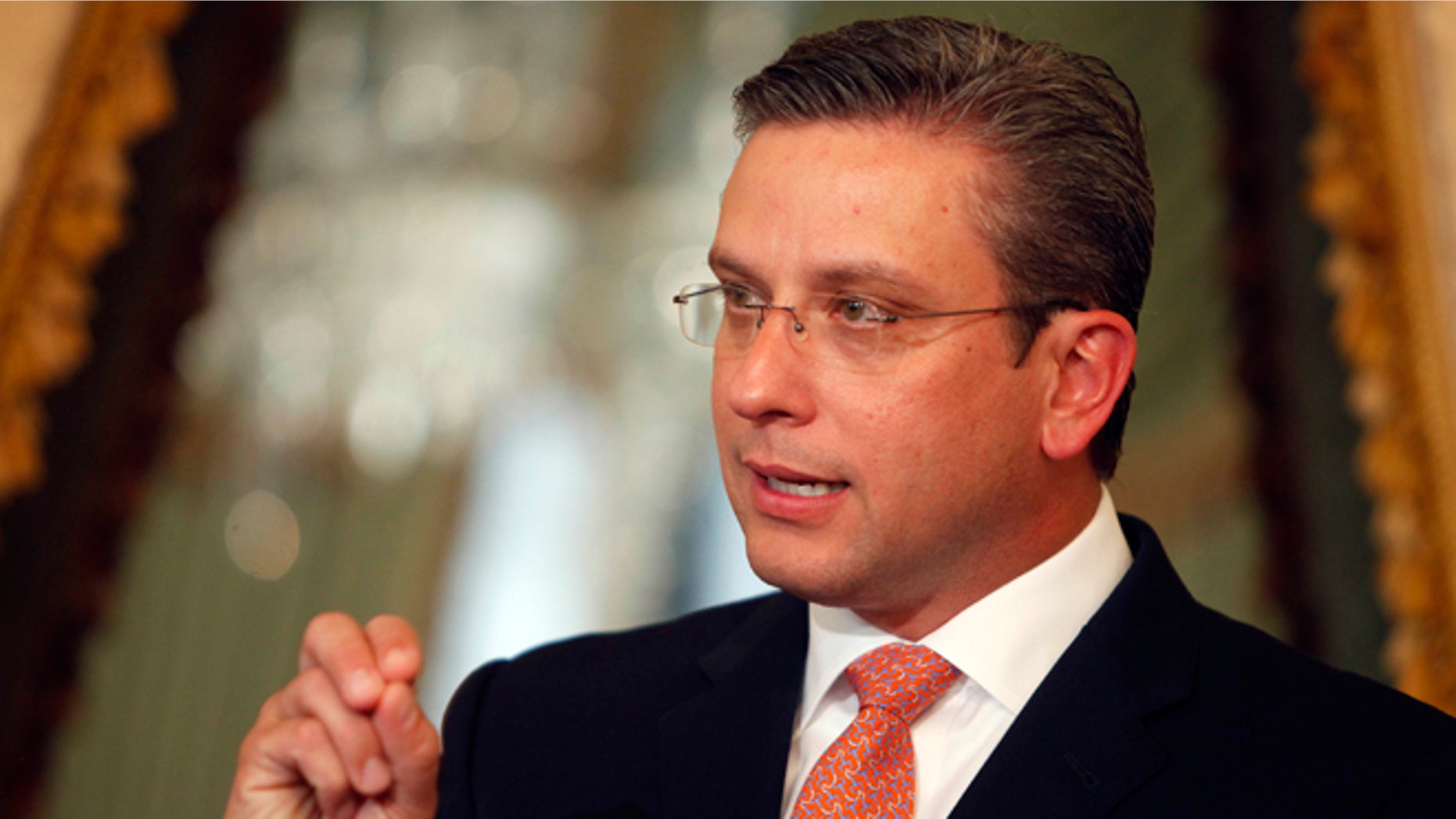 FILE - In this July 17, 2013 file photo, Puerto Ricoâs Gov. Alejandro Garcia Padilla speaks during a news conference at the governor's executive mansion in San Juan, Puerto Rico. Garcia Padilla says he plans to boost the island's sluggish coffee industry by generating thousands new jobs and cultivating an additional 16,000 acres (6,400 hectares) in the next two years. (AP Photo/Ricardo Arduengo, File)