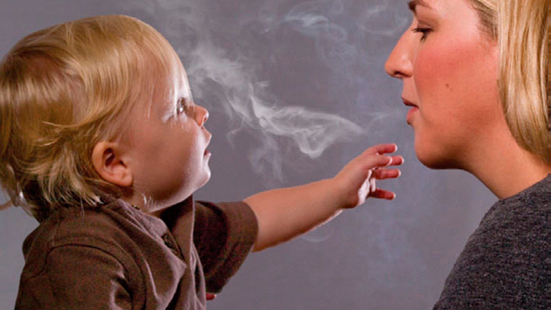 This handout image, released on November 10, 2010 depicts a mother blowing cigarette smoke in a child's face in one of the Federal Drug Administration's proposed new "graphic health warnings." Diseased lungs, dead bodies, a man on a ventilator and mothers blowing smoke in their children's faces are among the images unveiled on Wednesday that U.S. health officials are considering in their effort to revamp tobacco warning labels. REUTERS/HHS/Handout (UNITED STATES - Tags: BUSINESS POLITICS HEALTH) FOR EDITORIAL USE ONLY. NOT FOR SALE FOR MARKETING OR ADVERTISING CAMPAIGNS. THIS IMAGE HAS BEEN SUPPLIED BY A THIRD PARTY. IT IS DISTRIBUTED, EXACTLY AS RECEIVED BY REUTERS, AS A SERVICE TO CLIENTS