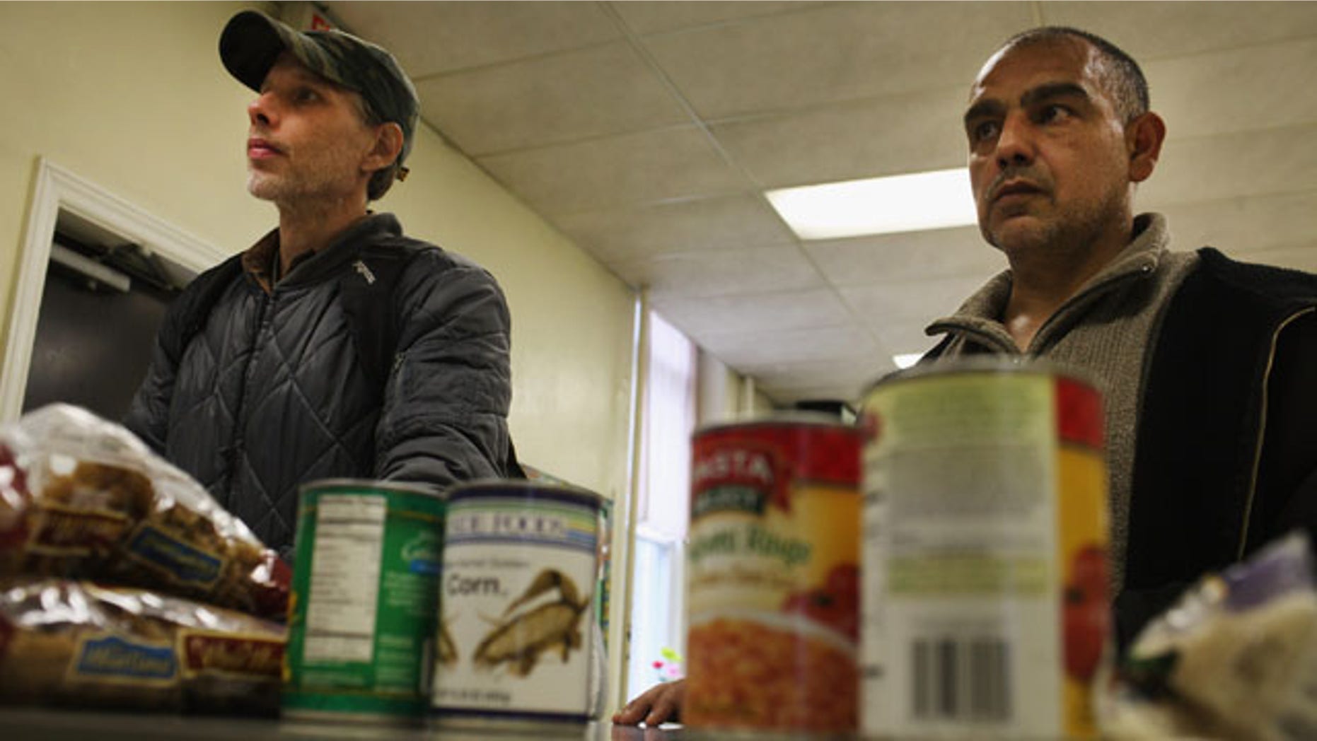READING, PA - OCTOBER 19: Men wait for groceries at the Central Park United Methodist Church weekly food pantry on October 19, 2011 in Reading, Pennsylvania. The U.S. Census says in a report released Nov. 7, 2011, that 28 percent of Latinos across the country live below the poverty line. (Photo by Spencer Platt/Getty Images)