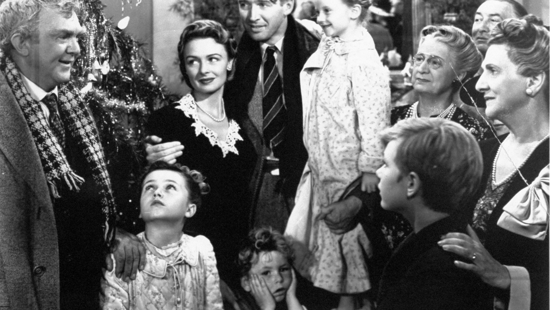 FILE - In this 1946 file photo originally provided by RKO Pictures Inc., legendary actor James Stewart as George Bailey, center, is reunited with his wife played by actress Donna Reed, third from left, and family during the last scene of Frank Capra's "It's A Wonderful Life." (AP Photo/RKO Pictures Inc.)