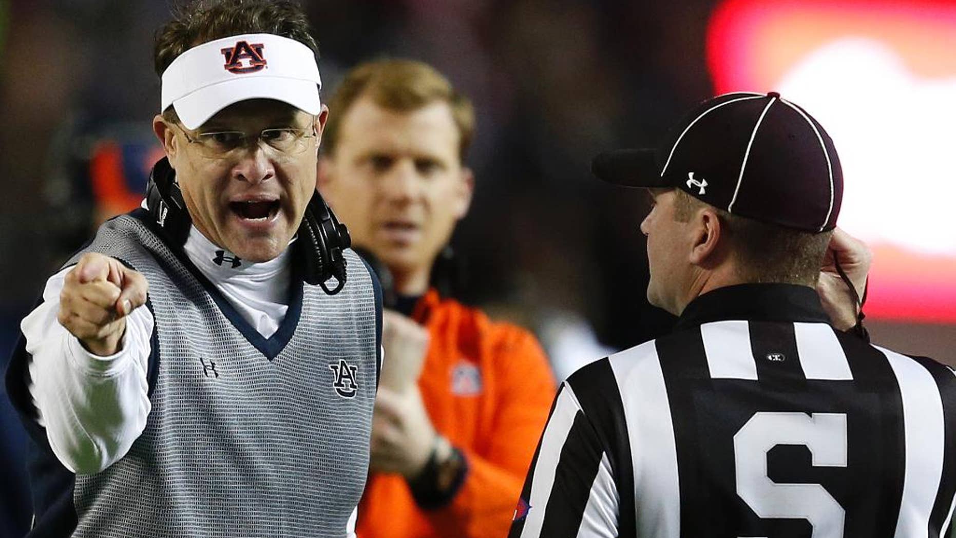 Auburn head coach Gus Malzahn speaks to official during the second half of the Iron Bowl NCAA college football game against Alabama, Saturday, Nov. 29, 2014, in Tuscaloosa, Ala. Alabama won 55-44. (AP Photo/Butch Dill)