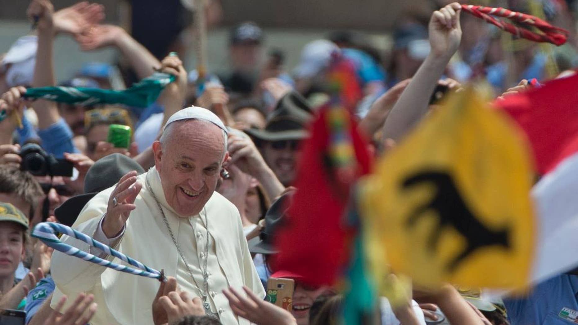 Pope Francis is cheered by the crowd as he arrives for an audience with Italian AGESCI boy scouts association's members in St. Peter's Square at the Vatican, Saturday, June 13, 2015. (AP Photo/Alessandra Tarantino)
