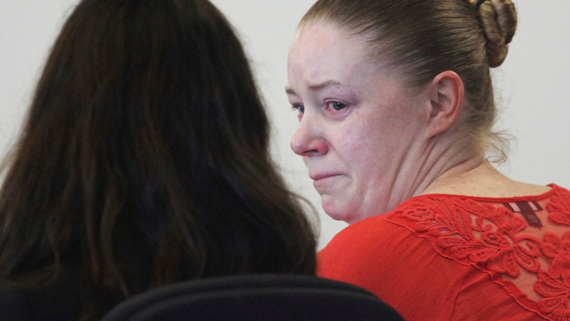 FILE - In this Tuesday, Sept. 3, 2013 file photo, Irish nanny Aisling Brady McCarthy, right, who is charged with murder and assault and battery on a child in the death of Rehma Sabir, sits with her attorney Melinda Thompson, during a hearing to request charges be dropped, in Middlesex Superior Court in Woburn, Mass. In court last week, McCarthy’s lawyers said two medical experts have concluded that the girl suffered bone fractures three to four weeks before her death when she was not in McCarthy’s care. Prosecutors say they will respond to the defense claims regarding the baby’s earlier injuries during a hearing Friday, Feb. 14, 2014. (AP Photo/The Boston Globe, Wendy Maeda, Pool, File)