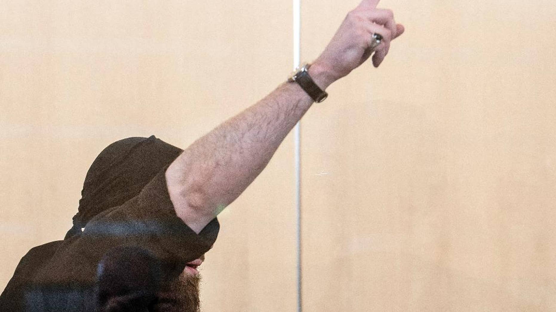 Defendant Marco G. stands in the courtroom during his trial in Duesseldorf, Germany, Monday, April 3, 2017. The regional court found Marco G. guilty of attempted murder over an explosive device placed at the main train station in the western city of Bonn in December 2012. (Federico Gambarini/dpa via AP)