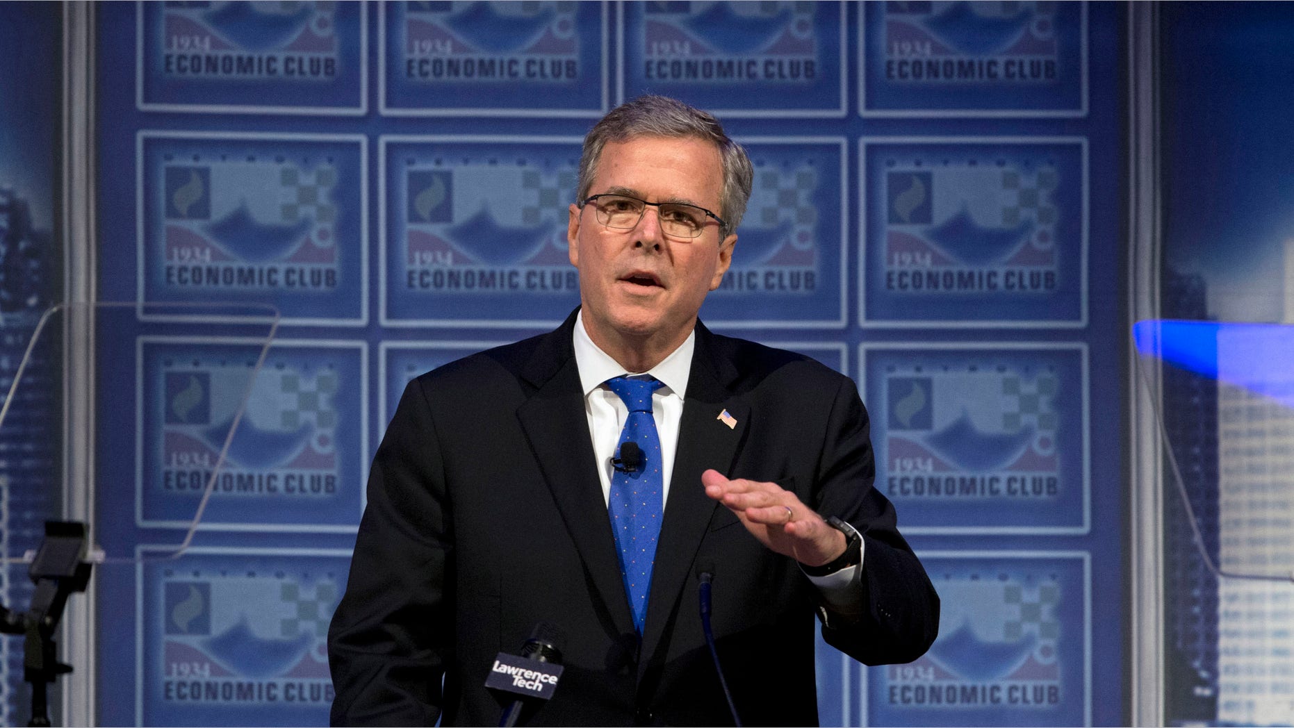 FILE - In this Feb. 4, 2015 file photo, former Florida Gov. Jeb Bush speaks at a Economic Club of Detroit meeting in Detroit. To Democrats, Jeb Bush offers an inviting target reminiscent of Mitt Romney's 2012 presidential campaign: Both opposed the government's rescue of U.S. automakers. Both worked in finance and backed the Wall Street bailout. Both have advocated for tax cuts that Democrats contend benefit the wealthy and big business. Starting the 2016 campaign, Democrats want to turn the former Florida governor into a carbon copy of Romney, who struggled against an onslaught of criticism related to his work in private equity and his portrayal by President Barack Obama's allies as a cold-hearted plutocrat. (AP Photo/Paul Sancya, File)