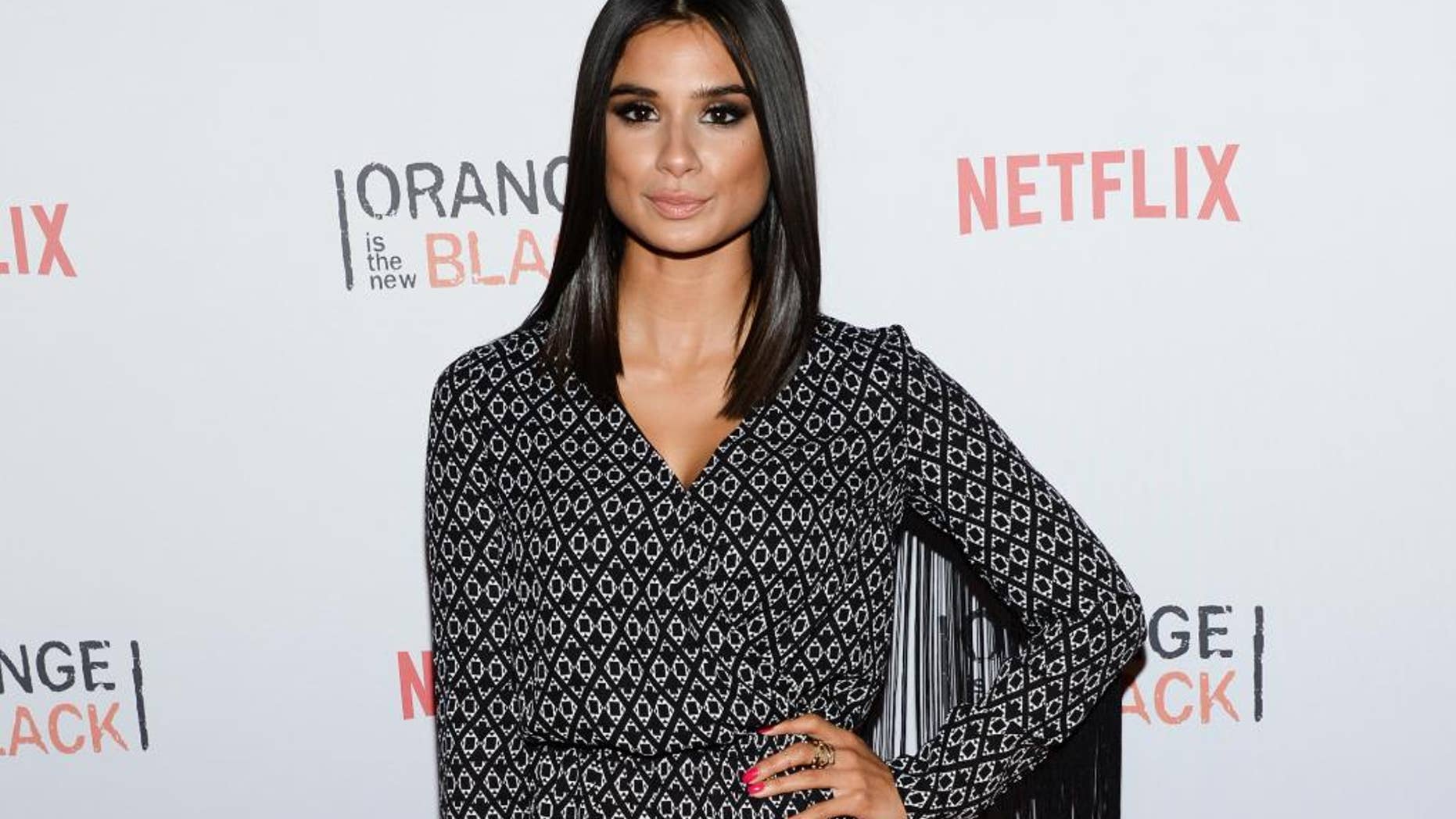 FILE- IN this June 11, 2015, file photo, actress Diane Guerrero attends Netflix's "Orange is the New Black" ORANGECON Celebration at Skylight Clarkson SQ in New York. The depression, the anxiety and the emotional instability that Guerrero went through due to the separation from her parents are some of the points she writes about in her new memoir "In the Country We Love: My Family Divided," as well as her later professional development and her work in the successful Netflix series "Orange Is The New Black" and The CW’s "Jane The Virgin." (Photo by Evan Agostini/Invision/AP)