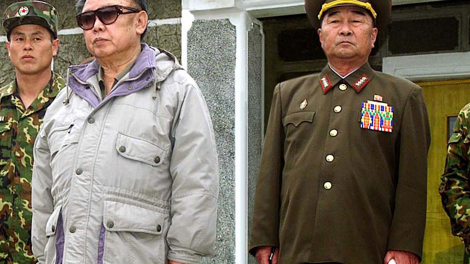 FILE - In this April 23, 2007 file photo released by Korean Central News Agency via Korea News Service in Tokyo, Gen. Kim Kyok Sik, right, stands with then-North Korean leader Kim Jong Il during the leader's inspection of Korean People's Army Unit 1637 at an undisclosed location in North Korea. North Korea replaced hard-line defense chief Kim Kyok Sik with little-known army general Jang Jong Nam. Mention of Jang's new role was buried Monday, May 13, 2013 in a state media dispatch listing those who attended an art performance with leader Kim Jong Un. (AP Photo/Korean Central News Agency via Korea News Service, File)