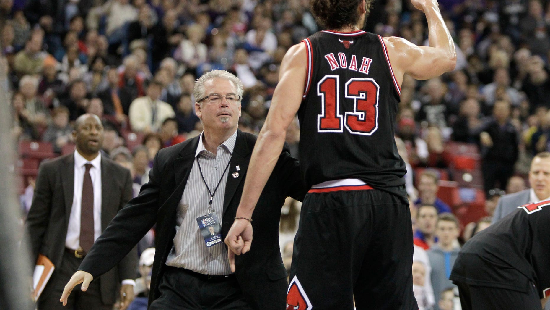 Chicago Bulls center Joakim Noah is restrained by Bulls security agent Eric Buck, after he was given his second technical foul and was ejected from the game in the third quarter against the Sacramento Kings in a NBA basketball game in Sacramento, Calif., Monday, Feb. 3, 2014. The Kings won 99-70. (AP Photo/Rich Pedroncelli)