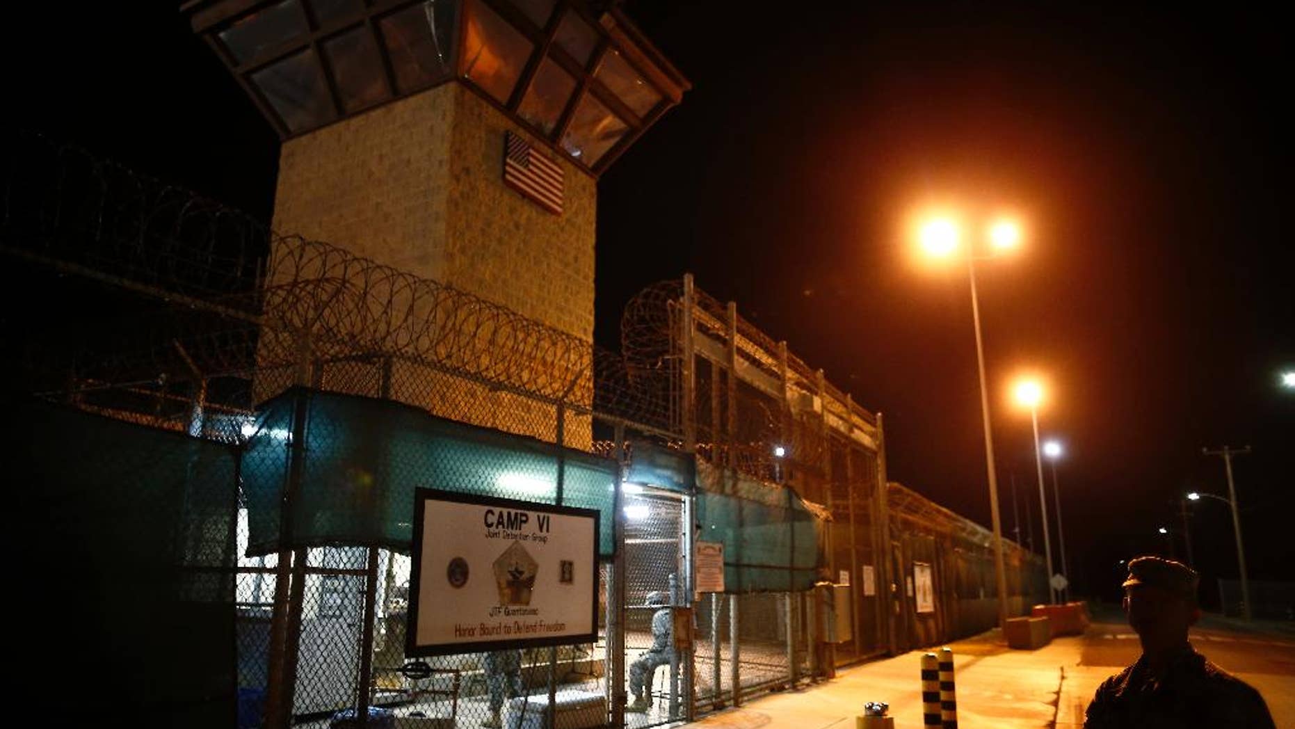 FILE - In this Nov. 20, 2013 file photo, reviewed by the U.S. military, the entrance to Camp VI detention facility is guarded at Guantanamo Bay Naval Base, Cuba. The House on Thursday, Sept. 15, 2016, backed election-year legislation that would temporarily halt the transfer of more terror suspects from the U.S. naval prison at Guantanamo Bay, Cuba. (AP Photo/Charles Dharapak, File)