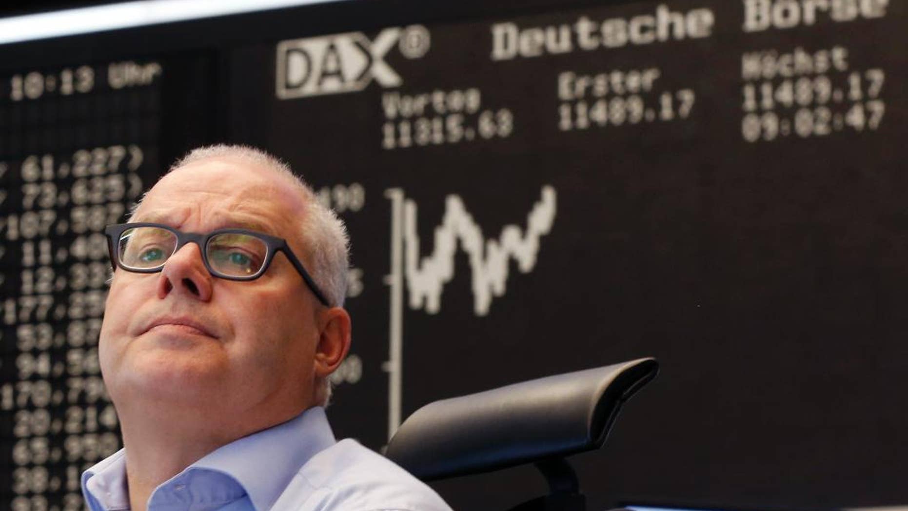 A trader watches his screens at the stock market in Frankfurt, Germany, Monday, July 13, 2015. Global stock markets bounced higher Monday after Greece and its European creditors agreed on a bailout deal, substantially reducing the uncertainty about Greece's future in the euro common currency. (AP Photo/Michael Probst)