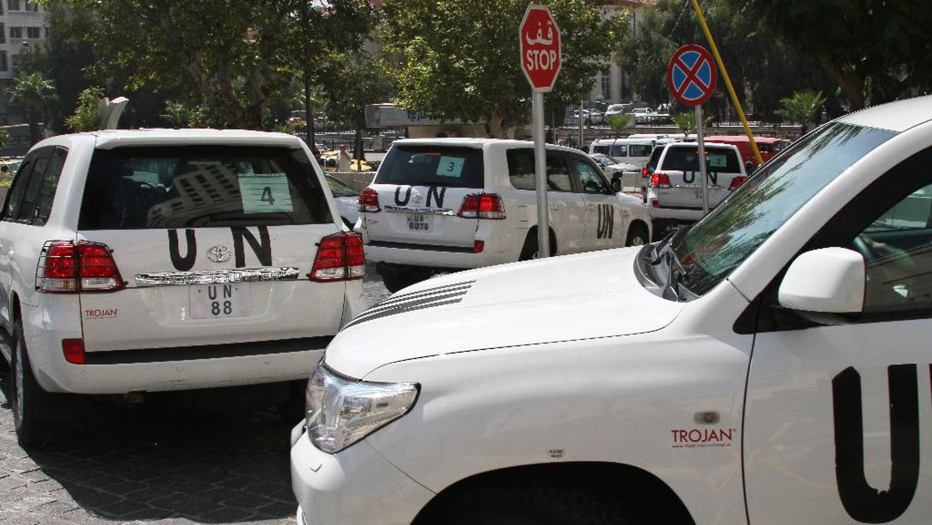 FILE -- In this August 26, 2013, file Photo, a U.N. team, that is scheduled to investigate an alleged chemical attack that killed hundreds last week in a Damascus suburb, leaves their hotel in a convoy, in Damascus, Syria. In a statement issued Tuesday, May 27, 2014, by the chemical weapons watchdog that is overseeing the dismantling of Syria's chemical weapons program, said a convoy of its inspectors has come under attack, but all are safe. The Organization for the Prohibition of Chemical Weapons said that the inspectors had been traveling to the site of an alleged chlorine gas attack site when they were attacked. (AP Photo, File)