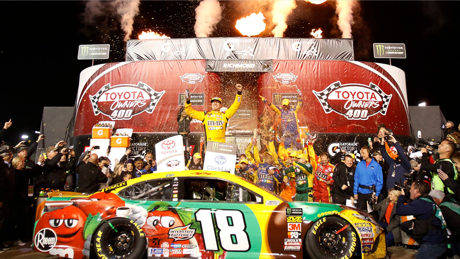 Kyle Busch, center, celebrates in Victory Lane after winning the NASCAR Cup Series auto race at Richmond Raceway in Richmond, Va., Saturday, April 21, 2018. (AP Photo/Steve Helber)