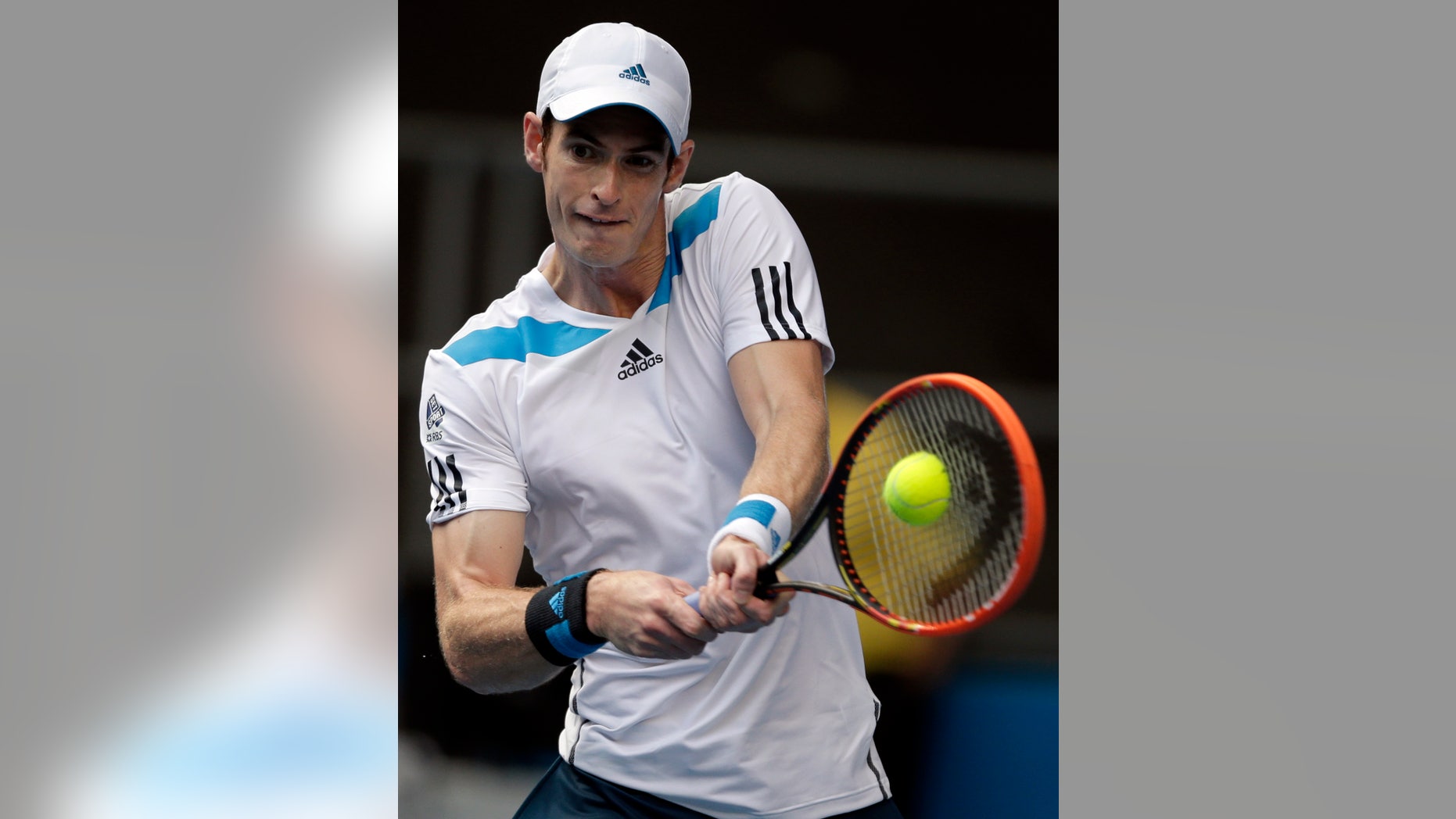 Andy Murray of Britain makes a backhand return to Stephane Robert of France during their fourth round match at the Australian Open tennis championship in Melbourne, Australia, Monday, Jan. 20, 2014.(AP Photo/Rick Rycroft)