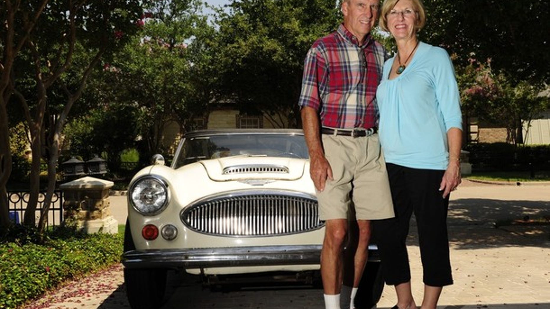 FILE: Bob Russell, right, and his wife Cyndy, pose in front of their 1967 Austin Healy, outside their Southlake, Texas home.