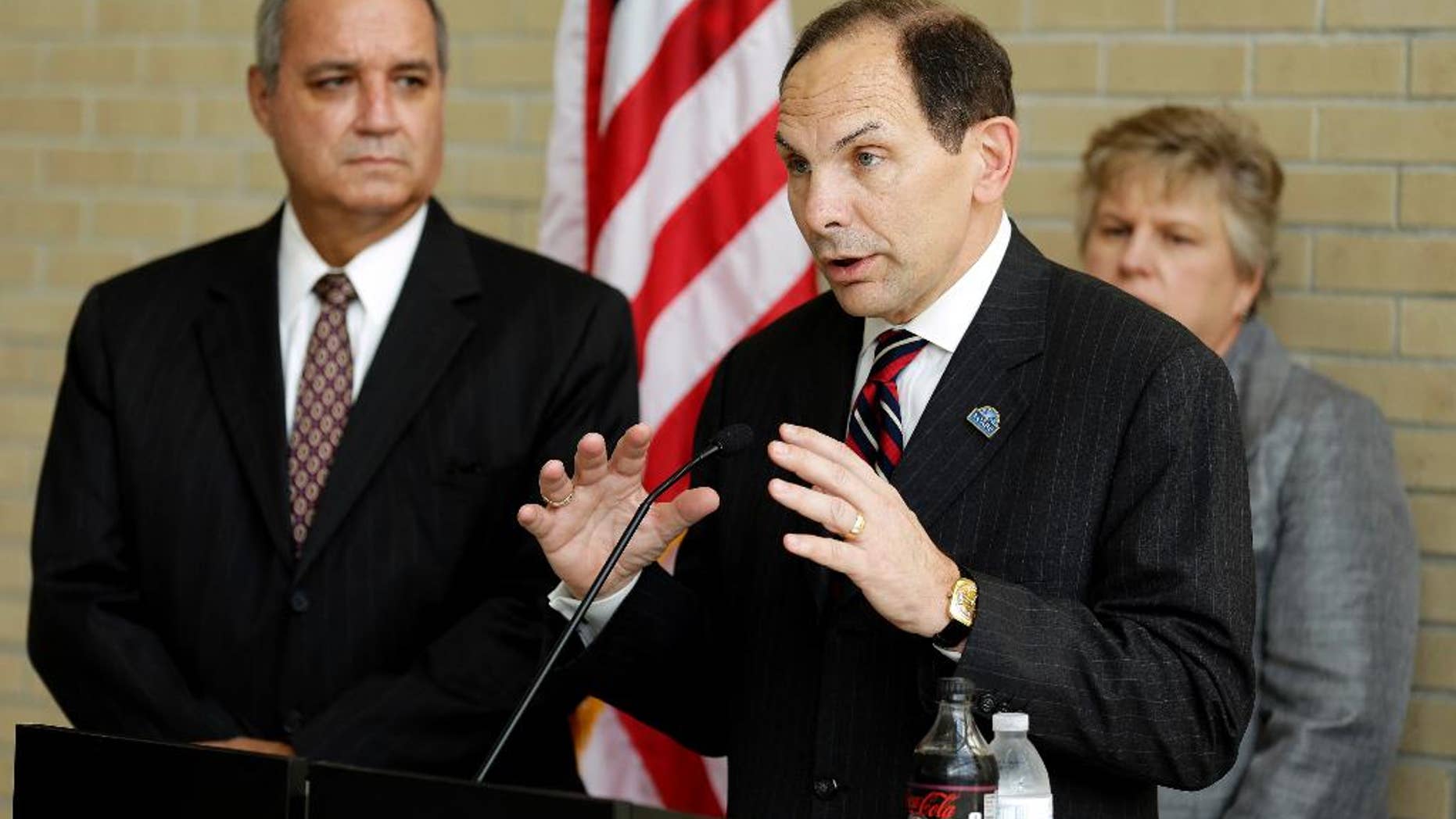 FILE - In this Oct. 1, 2014 file photo, Veterans Affairs Secretary Robert McDonald, center, accompanied by House Veterans Affairs Committee Chairman Rep. Jeff Miller, left, R-Fla., left, and Kathleen Fogarty, Director of the James A. Haley Medical Center, speaks at the James A. Haley Medical Center in Tampa, Fla. The Republican-led House is moving ahead on a bill aimed at making it easier for the Department of Veterans Affairs to fire employees for misconduct or poor performance, a source of ongoing tension with the Obama administration. (AP Photo/Chris O'Meara, File)