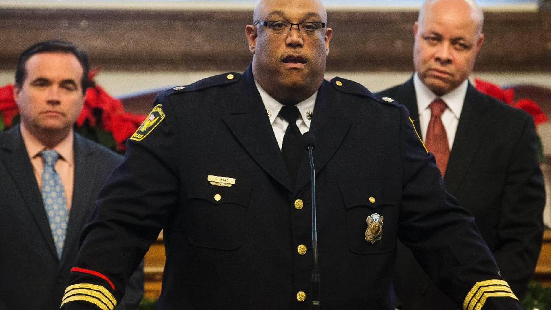 FILE – In this Dec. 10, 2015, file photo, Cincinnati Police Chief Eliot Isaac, center, Cincinnati Mayor John Cranley, left, and Cincinnati City Manager Harry Black, right, discuss Isaac's appointment as the city's permanent police chief during a news conference in Cincinnati. Following the fatal shooting of robbery suspect Jawari Porter on Sunday, Aug. 7, 2016, Cincinnati Police Chief Eliot Isaac says 25-year veteran police Officer Anthony Brucato had no choice but to fire at Porter, and Cincinnati Mayor John Cranley says Porter was trying to kill Brucato, who suffered minor injuries. (AP Photo/John Minchillo, File)