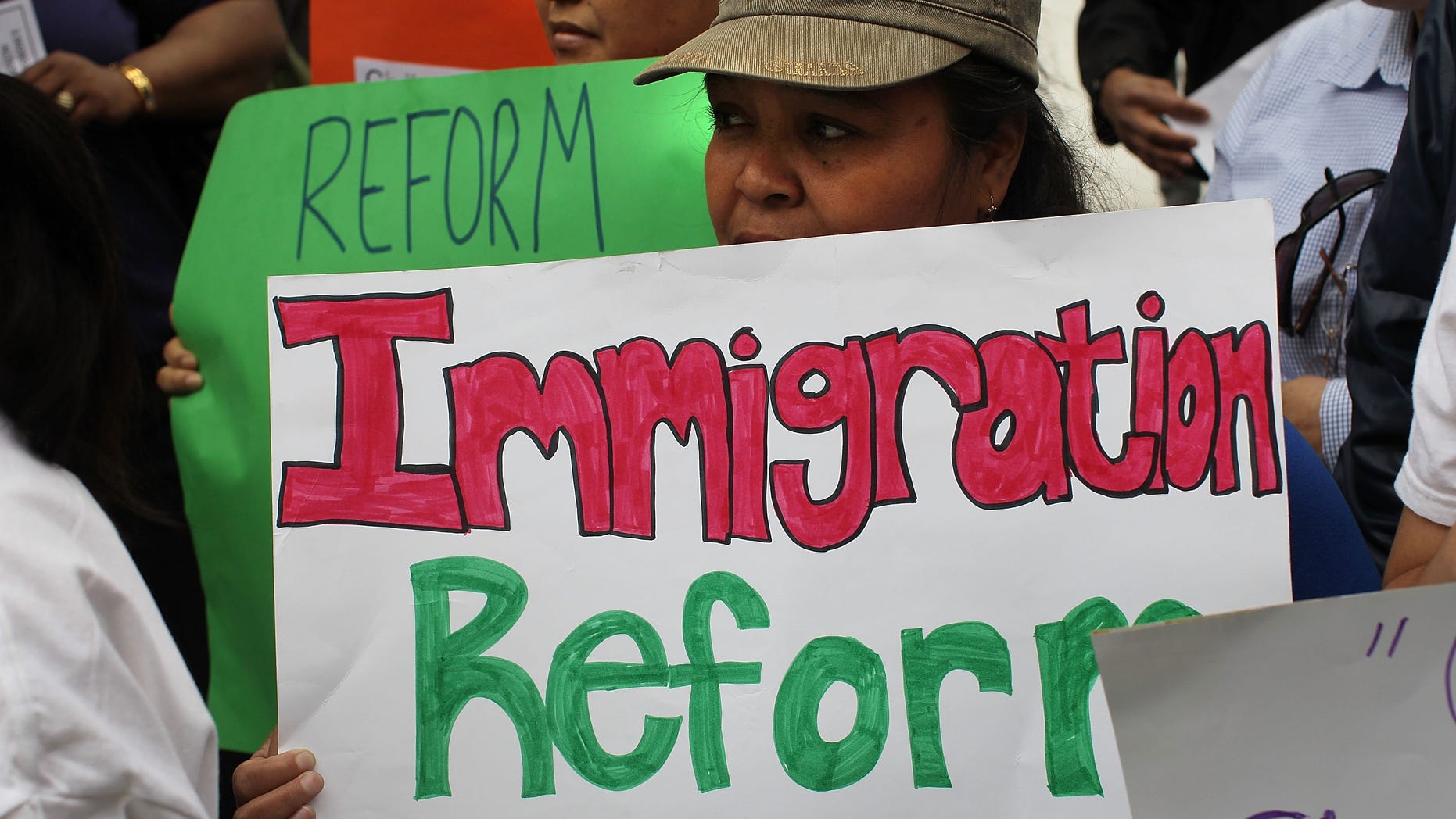 NEW YORK - MAY 17: People rally before an act of civil disobedience to protest against the lack of an immigration reform bill on May 17, 2010 in New York, New York. Nearly two dozen labor and community leaders, local clergy and City Council members were arrested while stopping traffic in front of 26 Federal Plaza. The protests follow the state of Arizona's passage of a new immigration law which requires individuals suspected of being illegal immigrants to show proof of legal residence when asked by law enforcement. The law has become increasingly divisive, with Mexico's president issuing a travel warning to Mexican citizens in Arizona. Thousands of people have been taking part in similar protests around the country. (Photo by Spencer Platt/Getty Images)