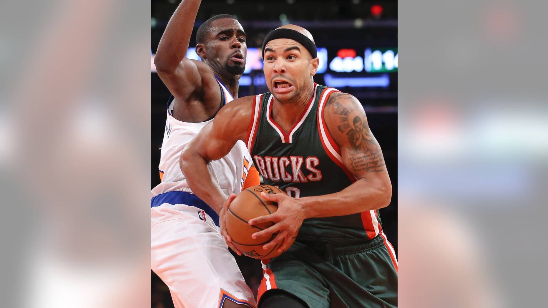 Milwaukee Bucks guard Jerryd Bayless (19) drives past New York Knicks guard Tim Hardaway Jr. in the second half of their preseason NBA basketball game at Madison Square Garden, Monday, Oct. 20, 2014, in New York. The Bucks won, 120-107. (AP Photo/John Minchillo)