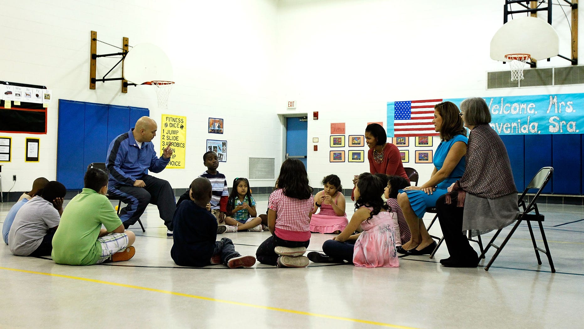 SILVER SPRING, MD - MAY 19: U.S. first lady Michelle Obama (3rd R) and her Mexican counterpart Margarita Zavala (2nd R) listen to PE teacher Thomas Ryan (L) during a physical education class as they visit New Hampshire Estates Elementary School, which was awarded the USDA?s Healthier US School Challenge Silver Award in 2009 and partnered with a school in Mexico as part of the Monarch Butterfly Sister School Program, May 19, 2010 in Silver Spring, Maryland. President of Mexico Felipe Calderon is on a state visit to Washington with the first lady of Mexico. (Photo by Alex Wong/Getty Images)
