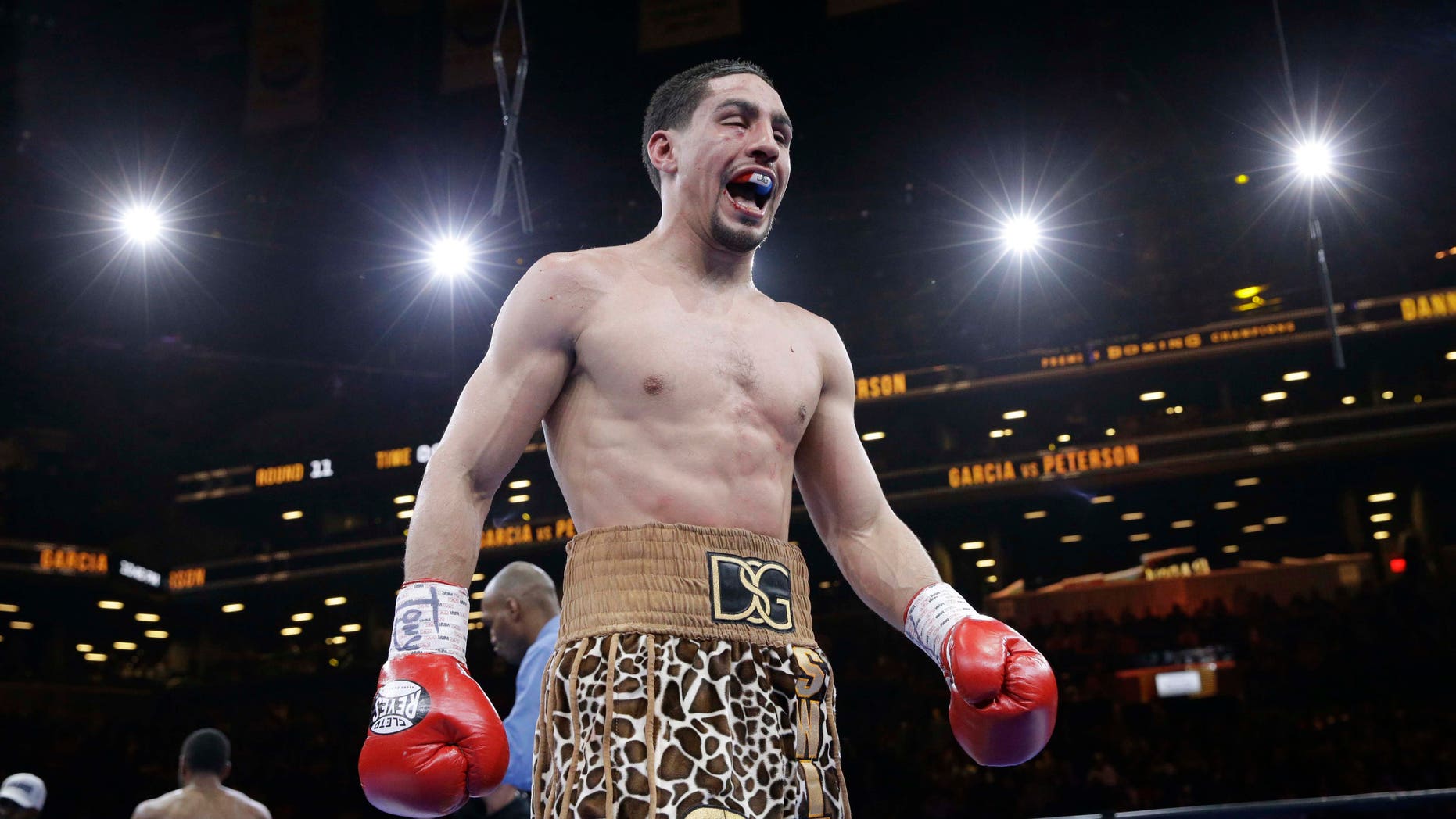 Danny Garcia reacts while returning to his corner after the 11th round during a super lightweight boxing match against Lamont Peterson, Saturday, April 11, 2015, in New York. Garcia won by a majority decision. (AP Photo/Mary Altaffer)