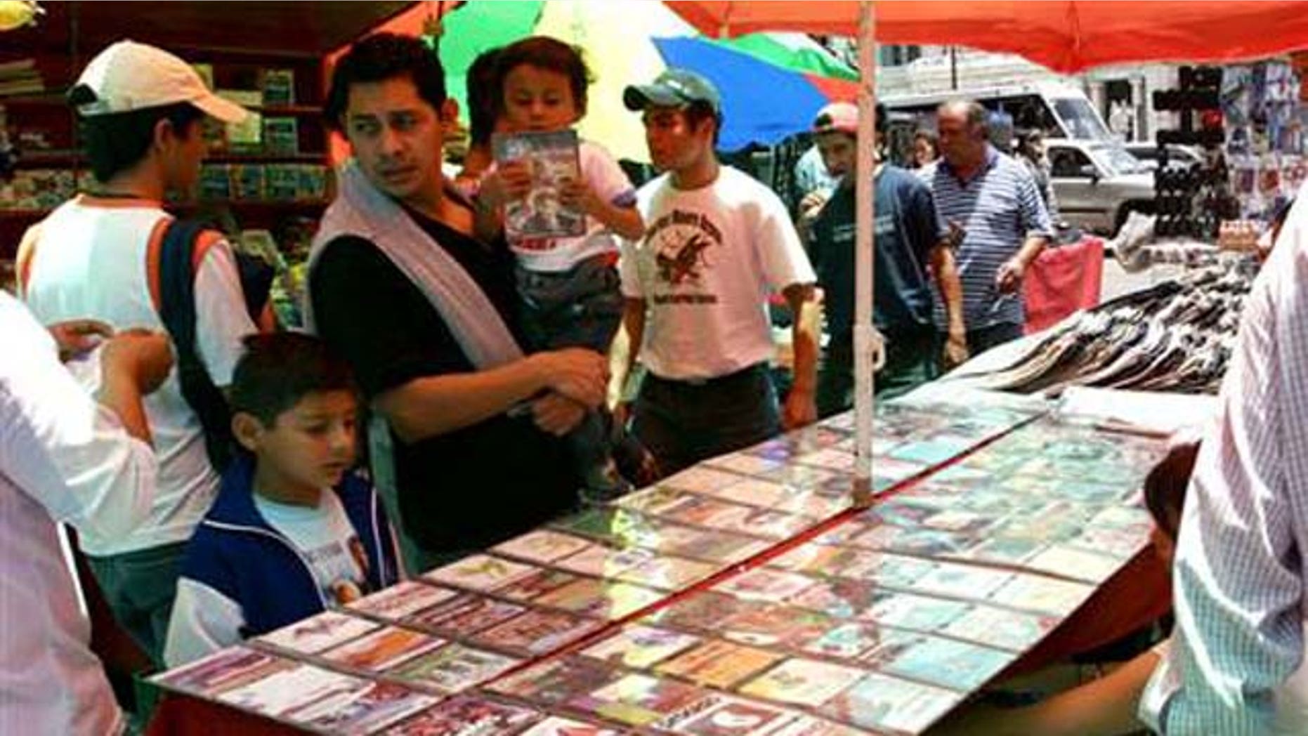 June 27, 2006: People shop for pirated CD's in downtown Mexico City.