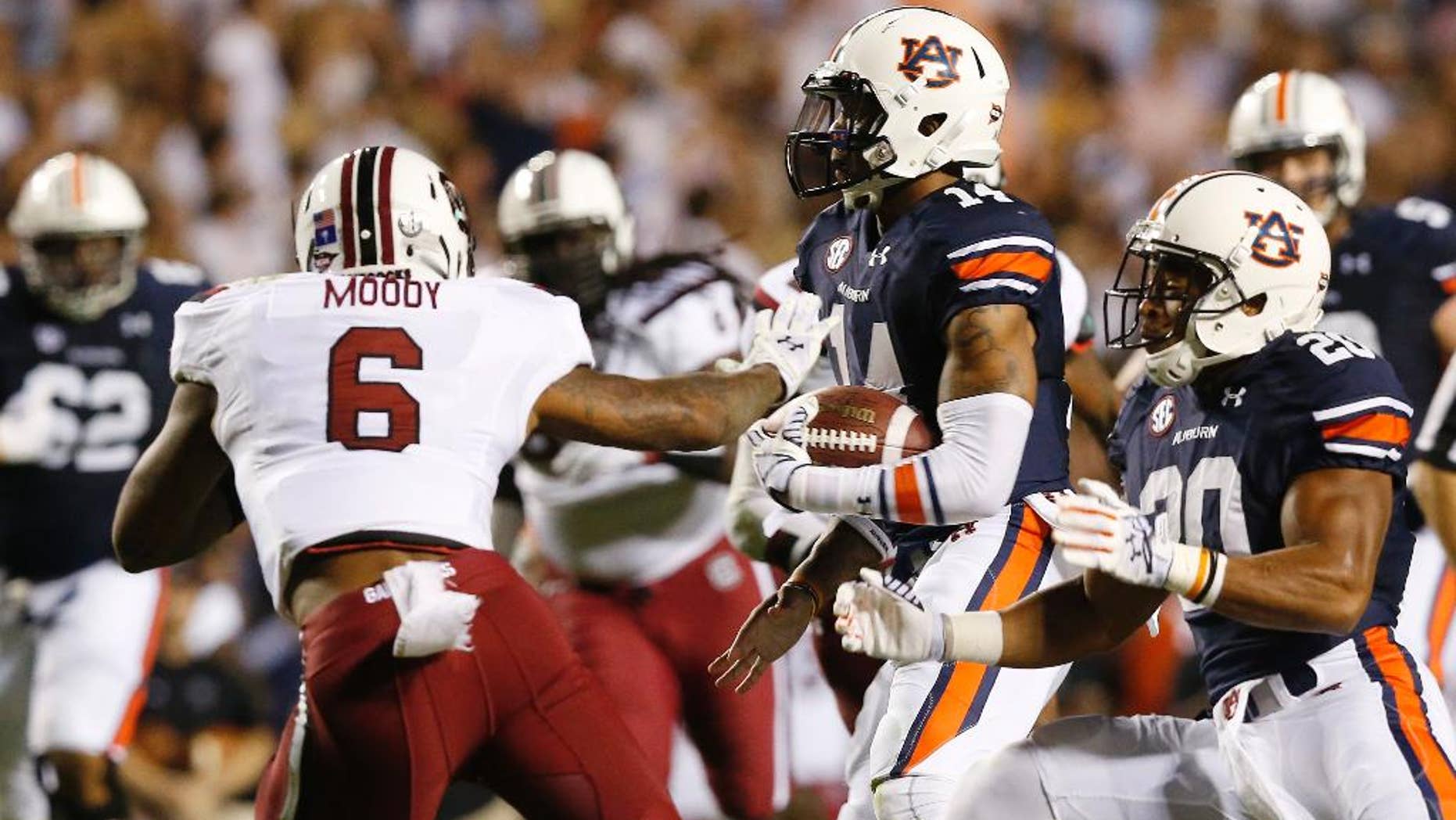 Auburn quarterback Nick Marshall (14) runs the ball in for a touchdown against South Carolina during the second half of an NCAA college football game Saturday, Oct. 25, 2014, in Auburn, Ala. Auburn won 42-35. (AP Photo/Brynn Anderson)