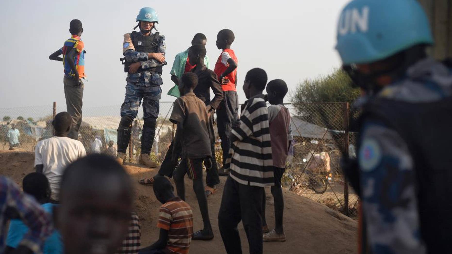 A United Nations peacekeeper standing with children near the U.N. base in Juba, South Sudan, in January.
