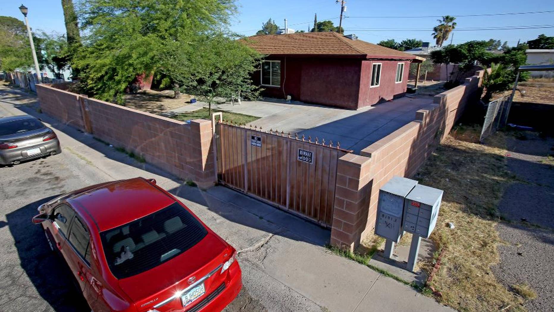 Police say five people were shot to death in a reported murder-suicide Tuesday evening at this home on the 800 block of West Calle Medina, Tucson, Ariz., shown Wednesday, May 13, 2015. Police got word of the bloodshed from a man who went to the house to meet someone, "peeked inside and noticed one individual who appeared to be deceased with multiple gunshot wounds," police Sgt. Pete Dugan said. (A.E. Araiza/Arizona Daily Star via AP) ALL LOCAL TELEVISION OUT; PAC-12 OUT; MANDATORY CREDIT; GREEN VALLEY NEWS OUT; MANDATORY CREDIT