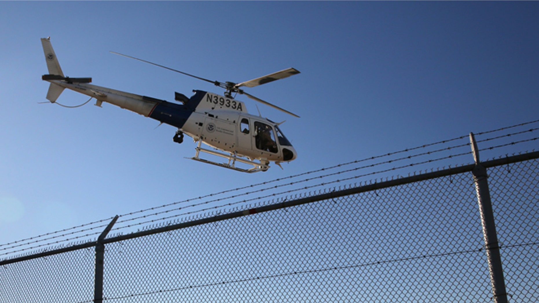 SAN DIEGO, CA - OCTOBER 01: A U.S. Office of Air and Marine (OAM) helicopter patrols near the U.S.-Mexico border on October 1, 2013 in San Diego, California. OAM helicopters support U.S. Border Patrol as well as Immigration and Customs Enforcement (ICE), personnel protecting border areas. While much of the Federal Government has closed down, personnel considered essential, such as border agents, remain working. (Photo by John Moore/Getty Images)
